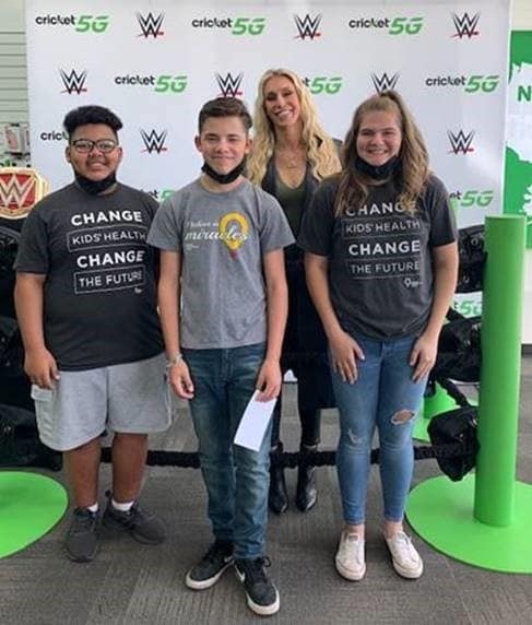 Charlotte Flair poses with fans